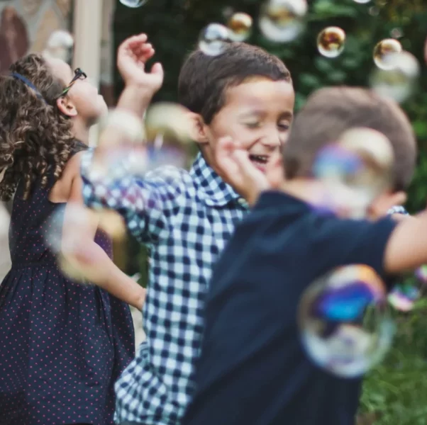 Are You Fully Alive? Kids running through bubbles
